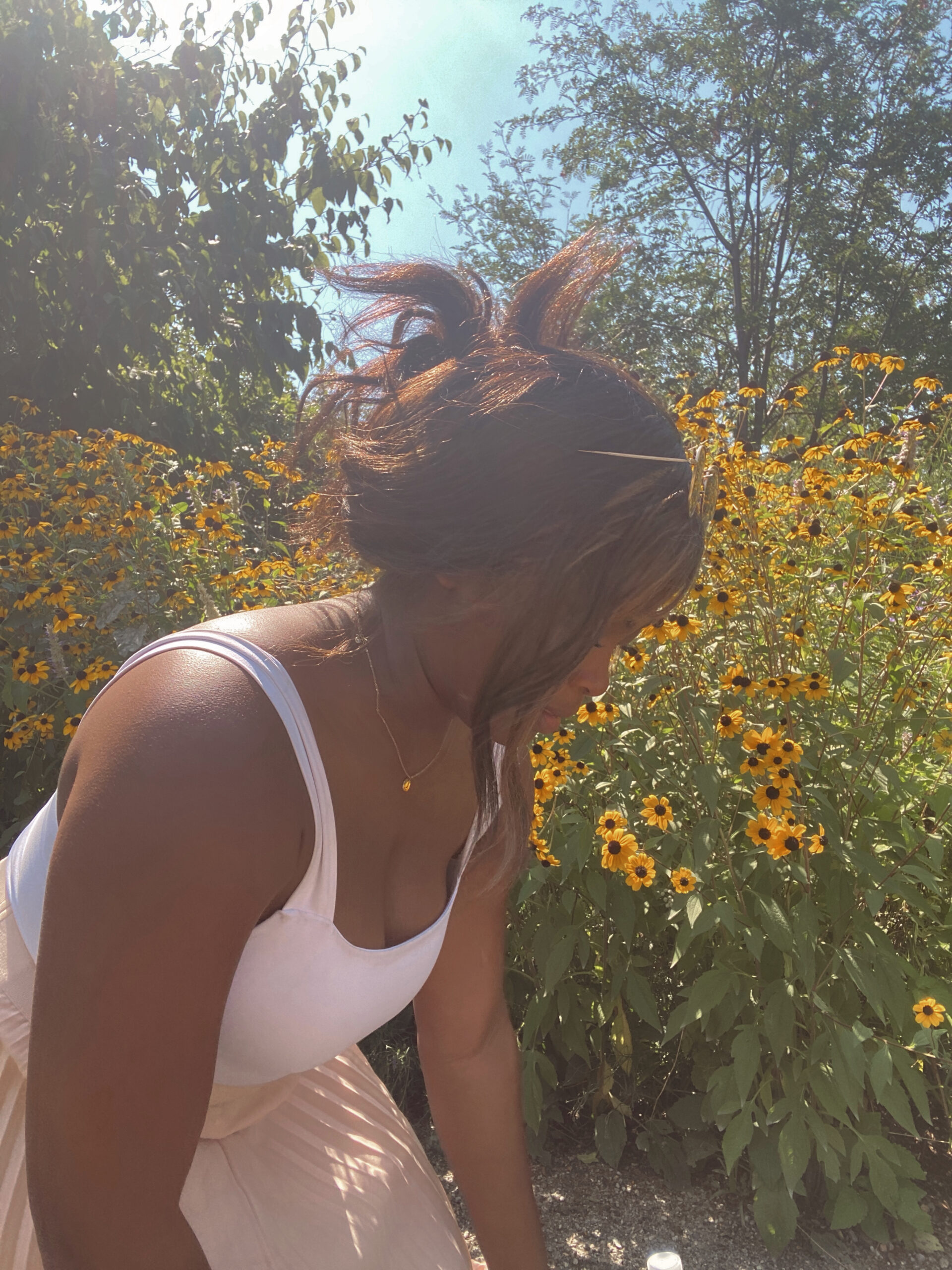 African American woman with her hair up in a field of flowers